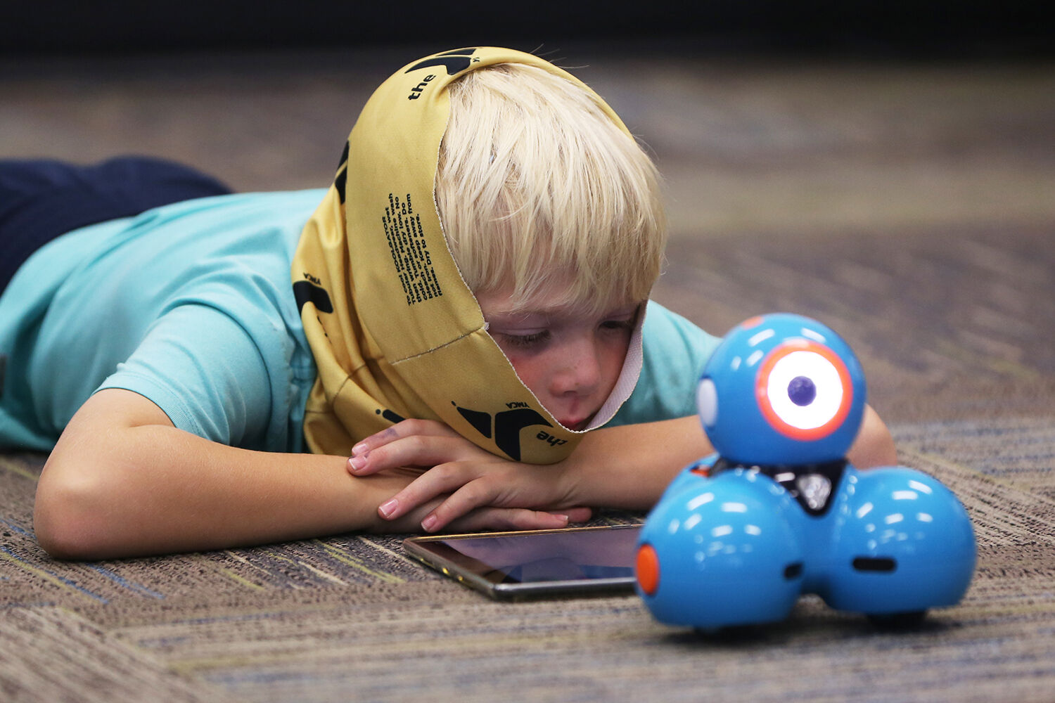 Finn Johnson lays down after arranging the code for his robot’s movement